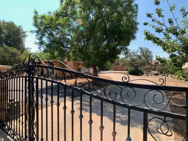 a view of a street with wooden fence