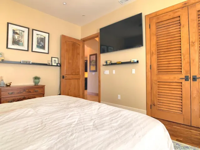 a bedroom with a bed and a potted plant