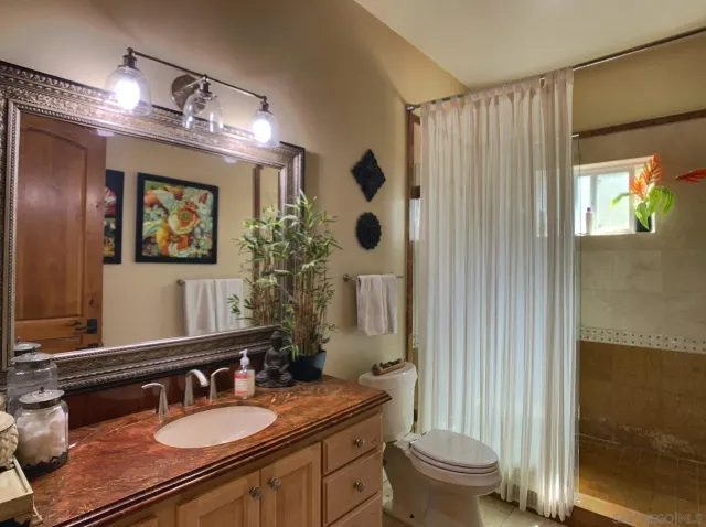 a view of a patio with a table and chairs under an umbrella