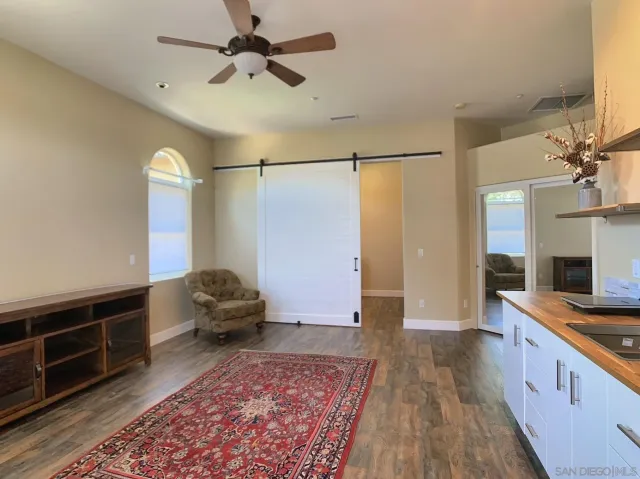 a view of swimming pool with lawn chairs and plants