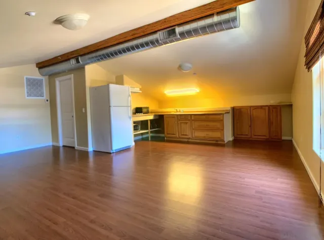 a kitchen with stainless steel appliances granite countertop a refrigerator a stove and a sink