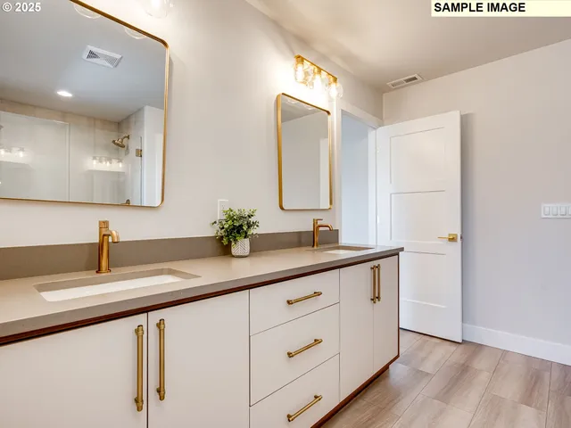 a bathroom with a double vanity sink and mirror