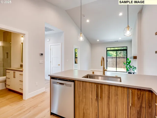 a kitchen with counter top space and wooden floor