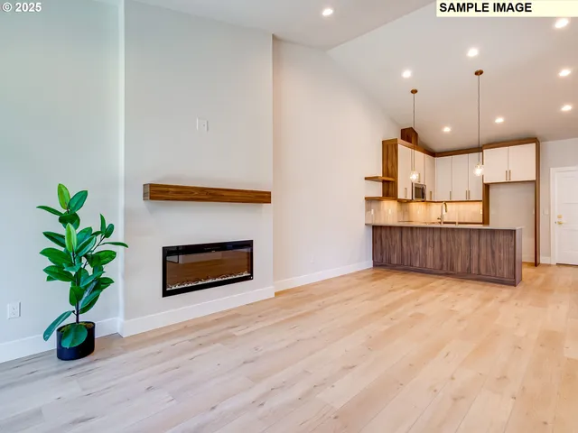 a view of kitchen with kitchen island a potted plant wooden floor and a potted plant