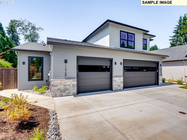 a front view of a house with yard and garage