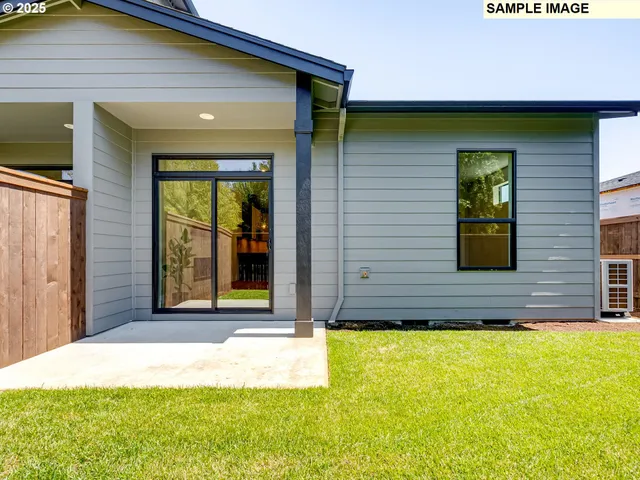 a view of a brick house with a small yard