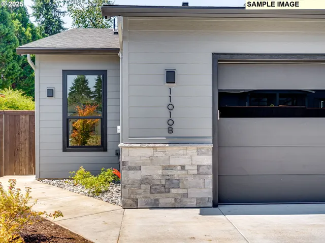 a front view of a house with potted plants