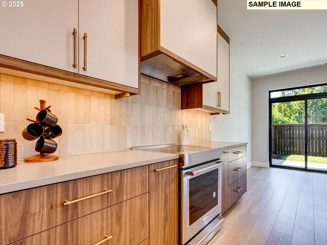 a kitchen with stainless steel appliances granite countertop a stove and a sink