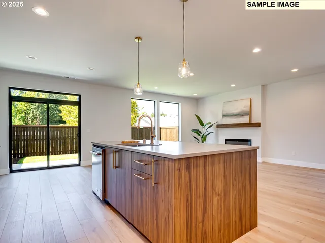 a kitchen with stainless steel appliances granite countertop wooden floors and sink
