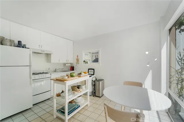 a utility room with cabinets washer and dryer