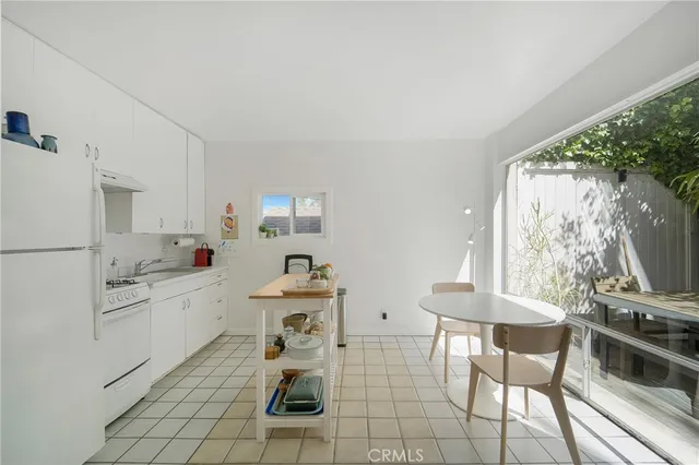 a kitchen with granite countertop a sink appliances cabinets and furniture