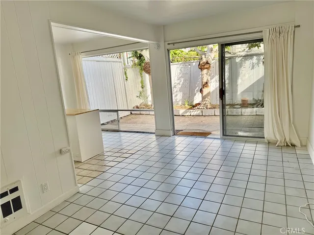 a view of empty room with wooden floor and floor to ceiling window