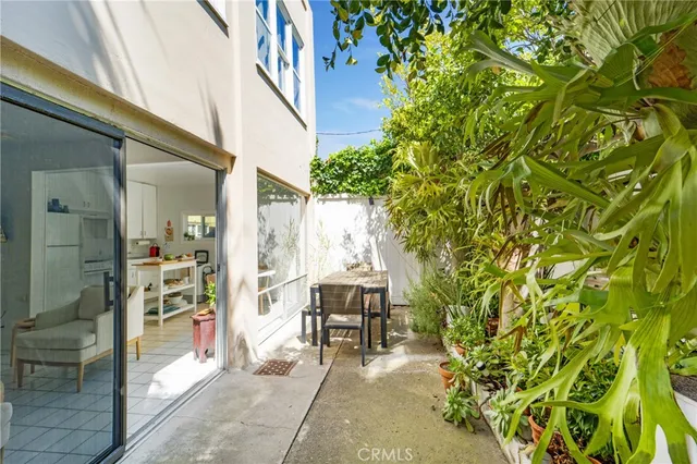 a view of a patio with table and chairs and potted plants