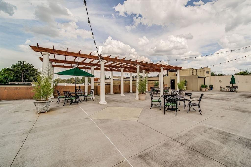 5300 Peachtree Road, Unit 2604 Atlanta, GA 30341 - Photo 30 of 39 a view of a patio with table and chairs under an umbrella