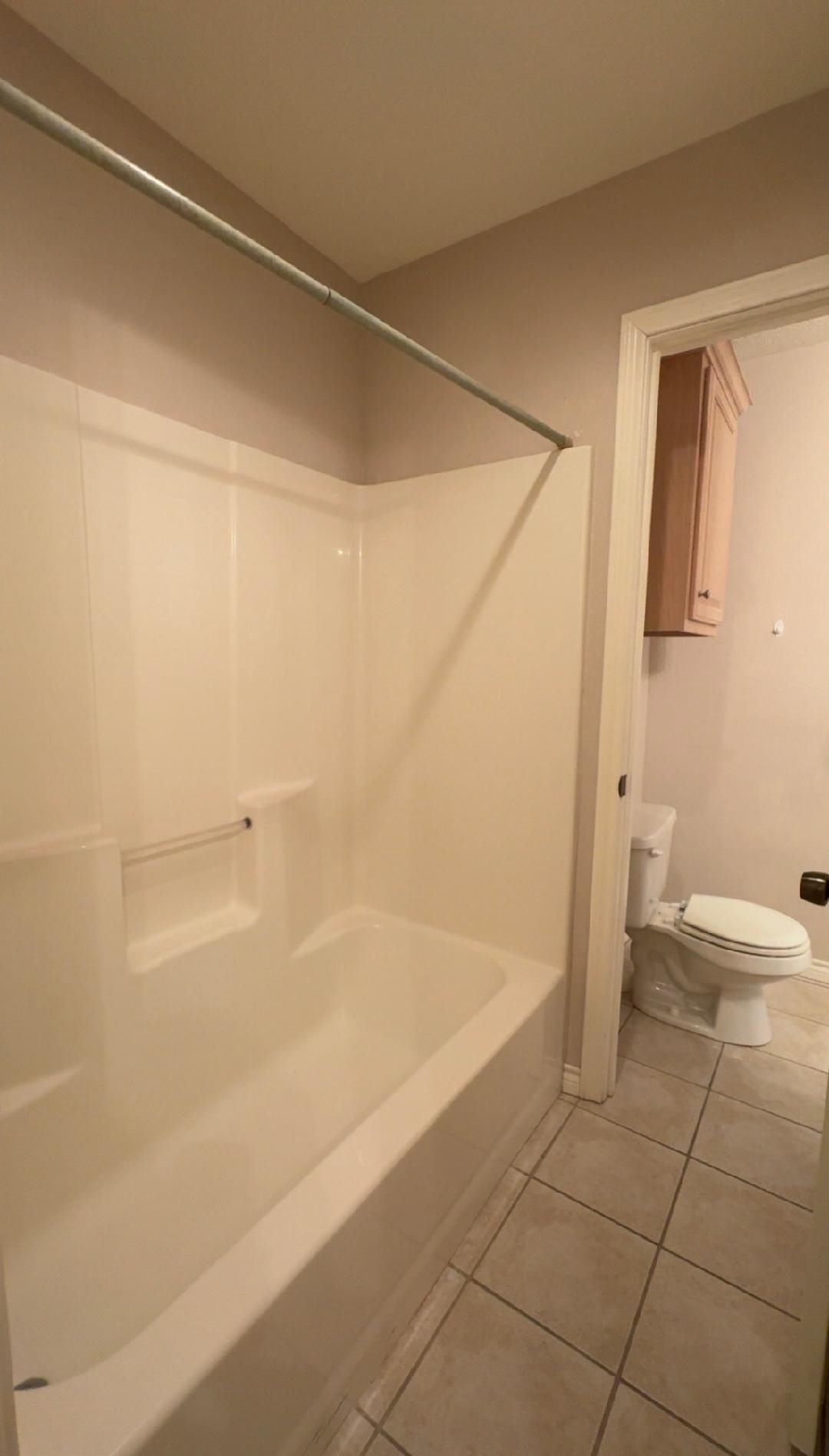 4665 Glen Oaks Circle Beaumont, TX 77708 - Photo 12 of 20 a bathroom with a bathtub and a shower