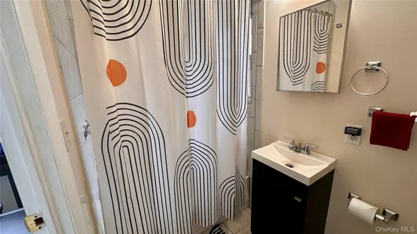 a bathroom with a sink a mirror and a shower curtain