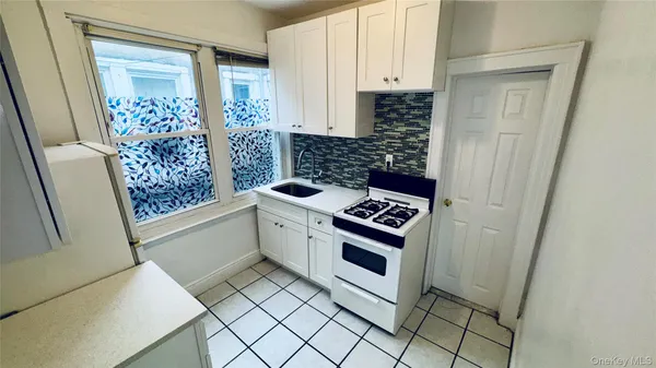 a kitchen with a refrigerator and a stove