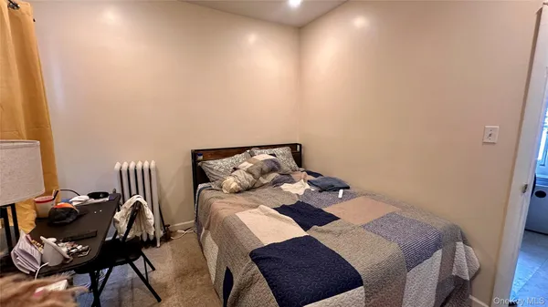 a bedroom with furniture and a large window