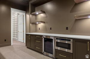 1141 East Lost Ridge Drive Washington, UT 84780 - Photo 93 of 108 Built-in cabinetry with a light-toned countertop, stainless steel appliances, and illuminated floating shelves