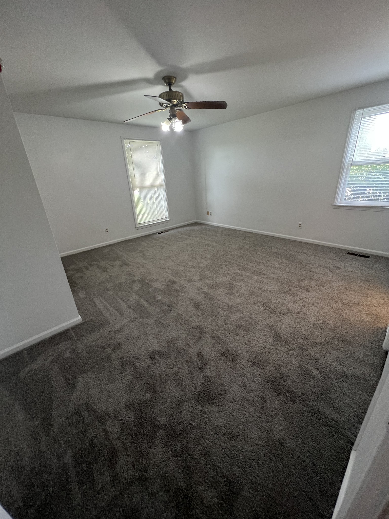 5588 Lebanon Road Lebanon, TN 37087 - Photo 20 of 43 an empty room with a chandelier fan and windows