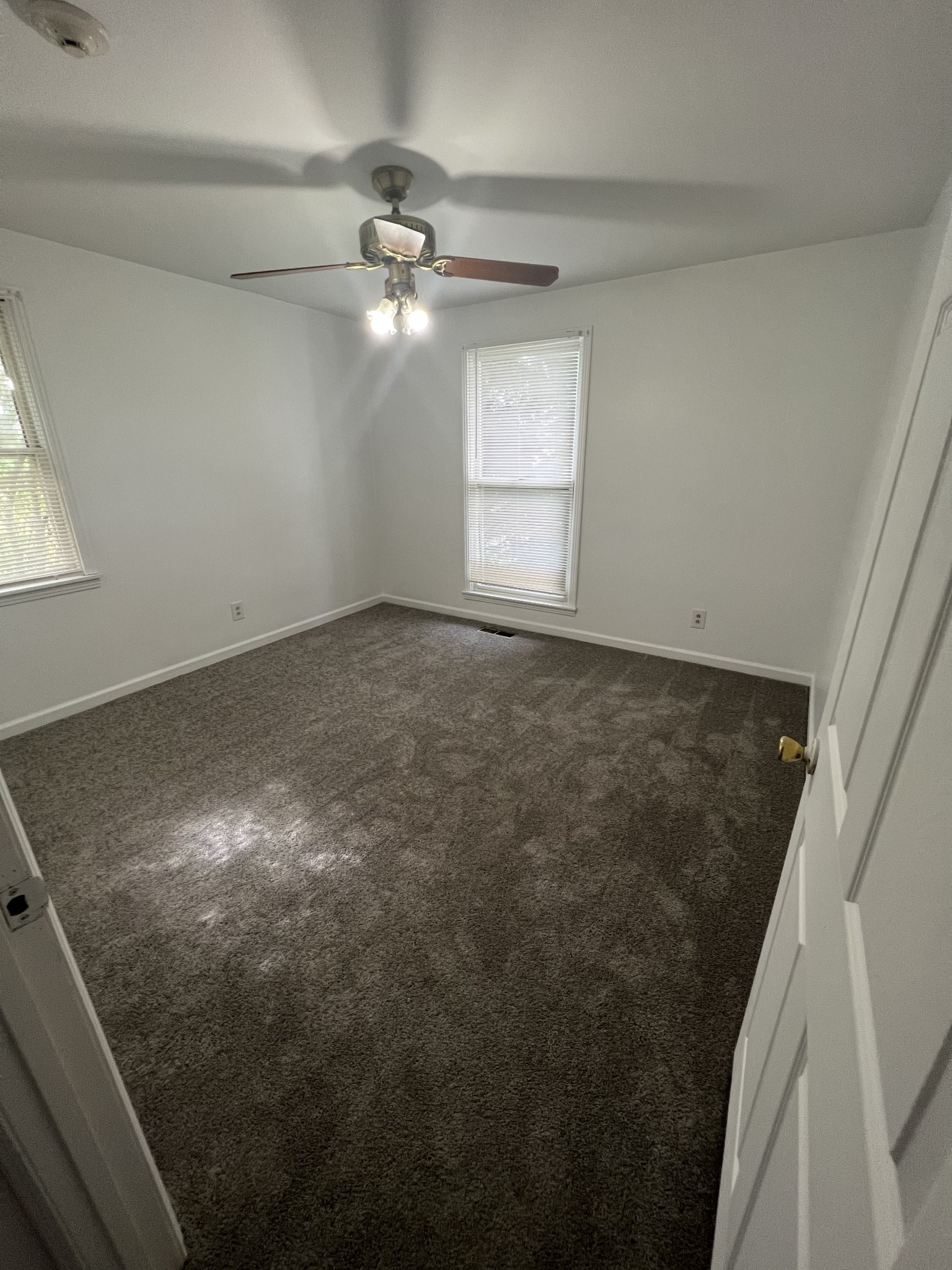 5588 Lebanon Road Lebanon, TN 37087 - Photo 9 of 43 an empty room with a chandelier fan and windows