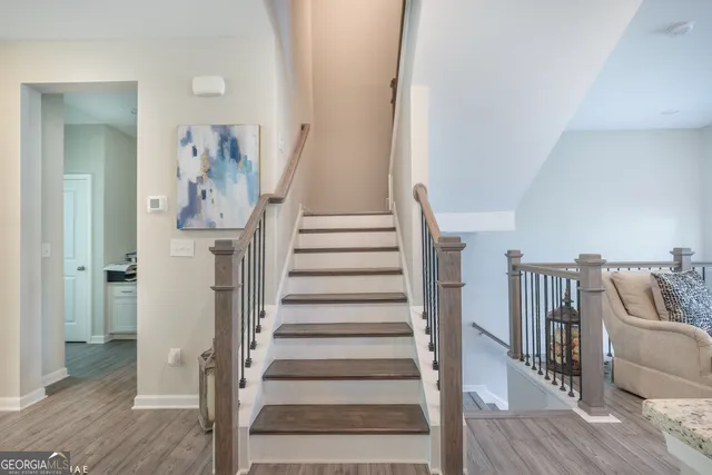 a view of entryway and hall with wooden floor