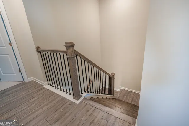 a view of a hallway with wooden floor