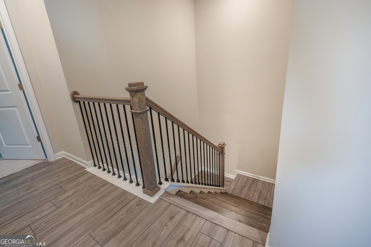 2247 Pink Hawthorn Drive Buford, GA 30518 - Photo 13 of 43 a view of a hallway with wooden floor
