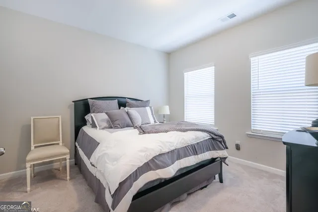 a bedroom with a bed and chair