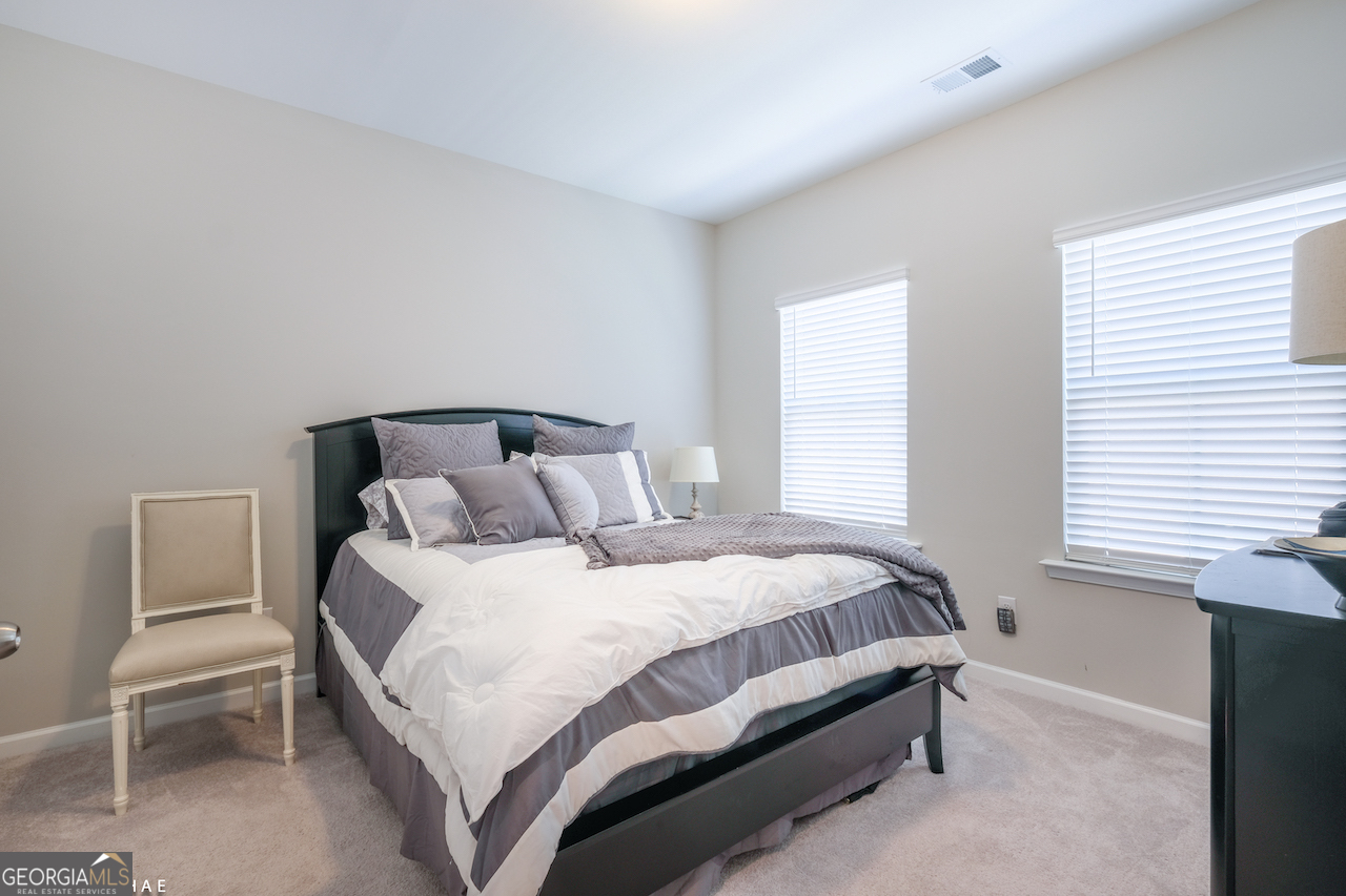 2247 Pink Hawthorn Drive Buford, GA 30518 - Photo 14 of 43 a bedroom with a bed and chair