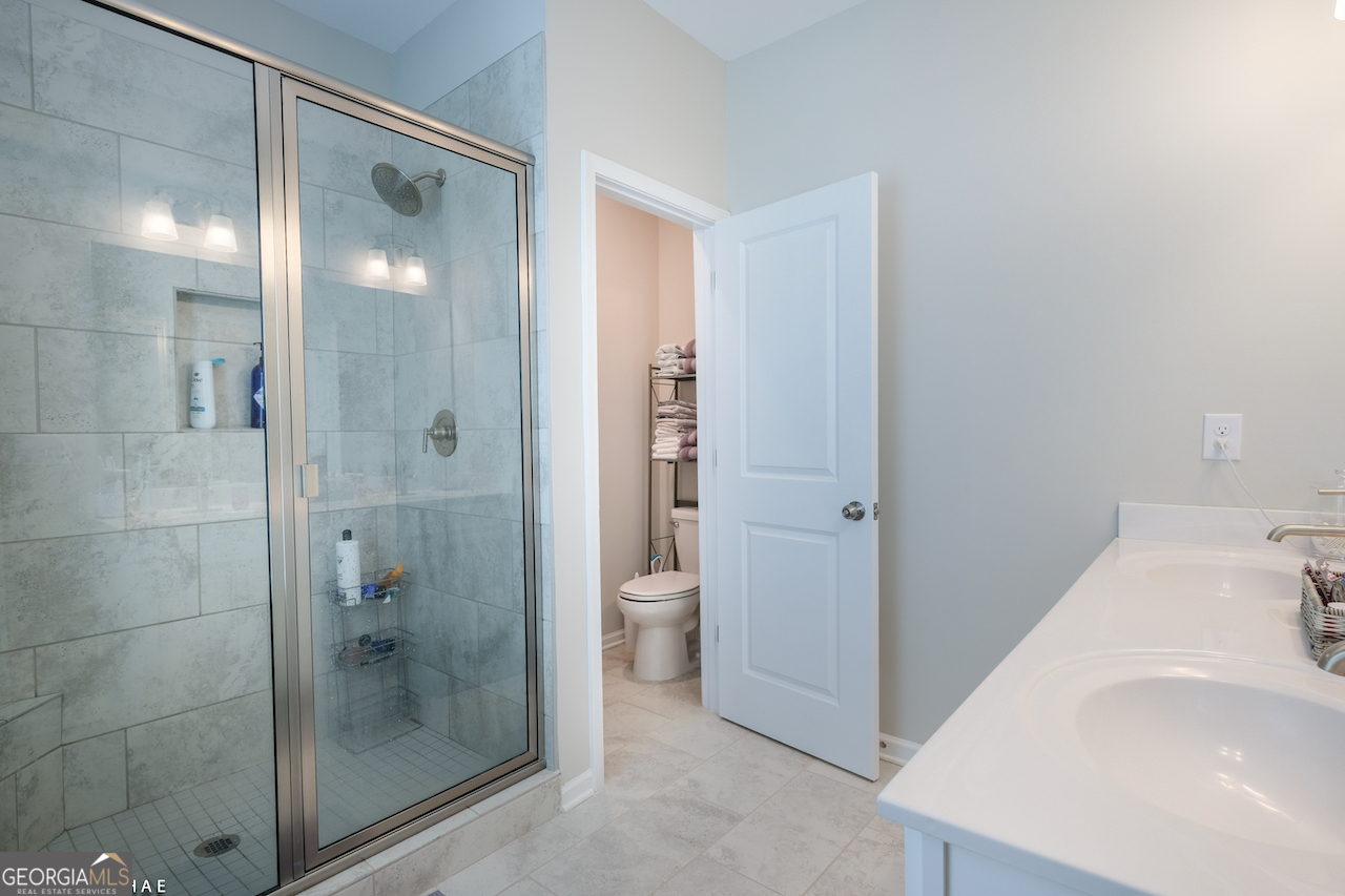 2247 Pink Hawthorn Drive Buford, GA 30518 - Photo 18 of 43 a bathroom with a bathtub and a sink