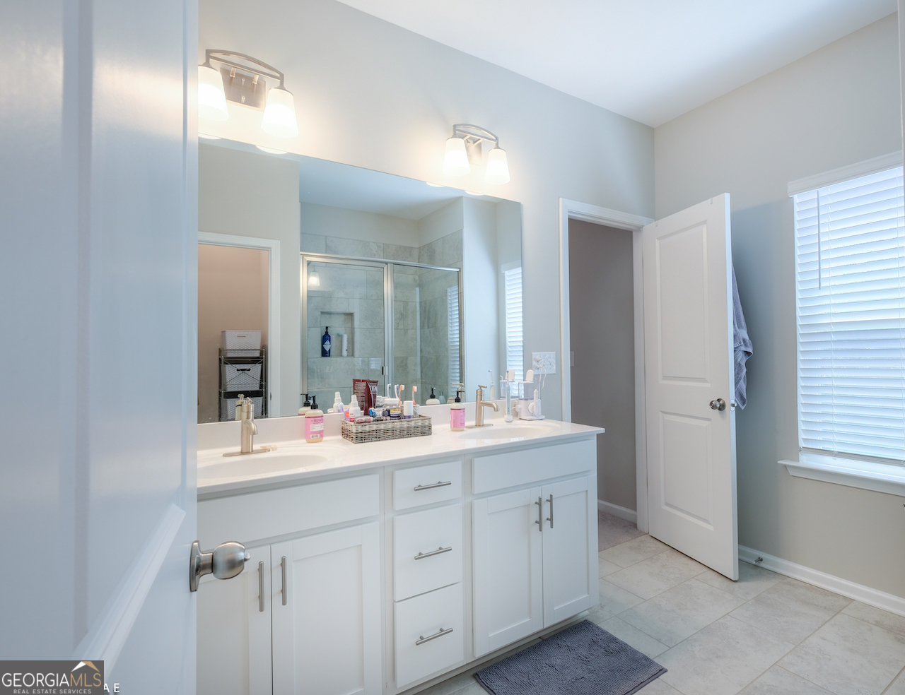 2247 Pink Hawthorn Drive Buford, GA 30518 - Photo 19 of 43 a bathroom with a sink and a mirror