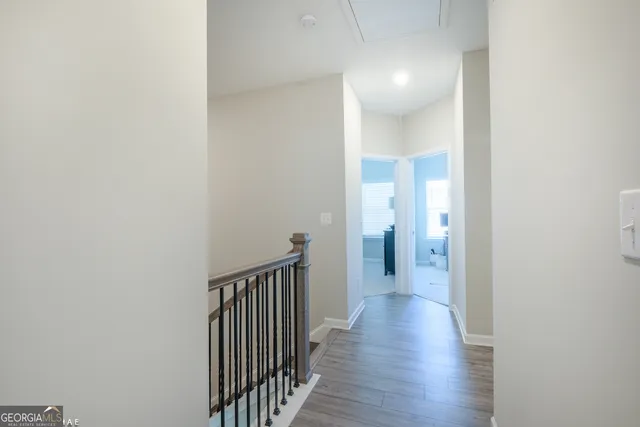 a view of a hallway with wooden floor