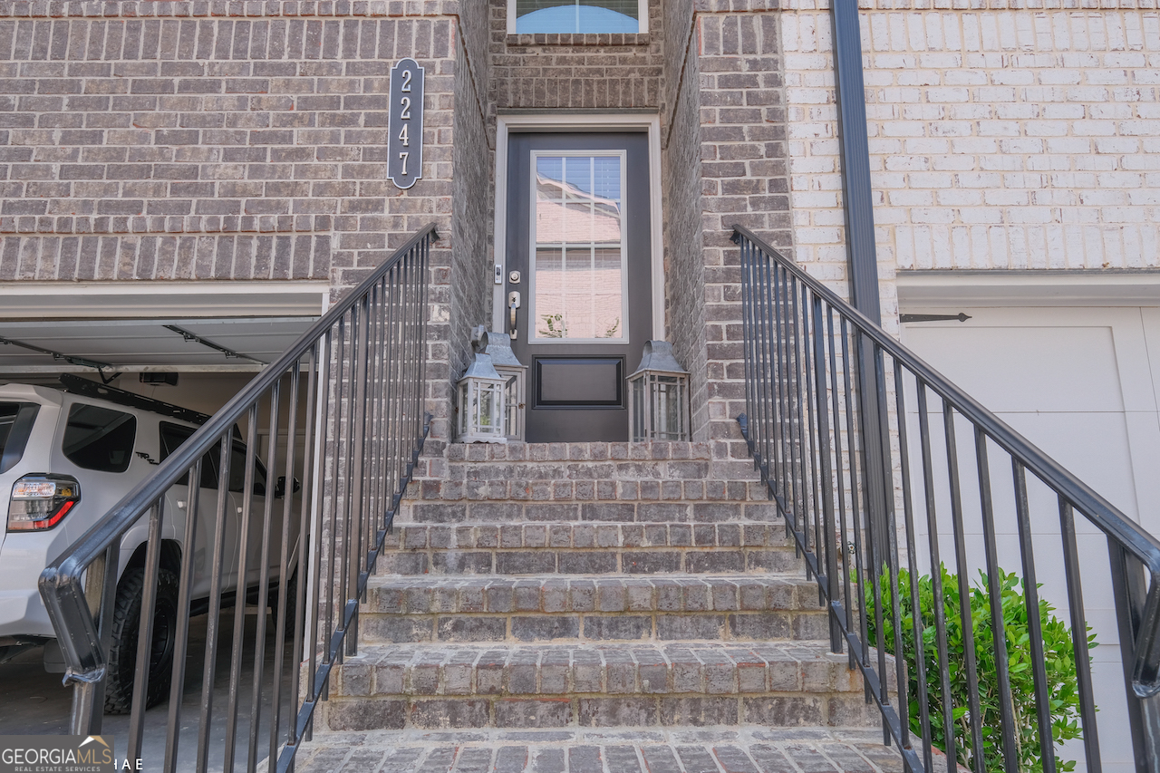 2247 Pink Hawthorn Drive Buford, GA 30518 - Photo 2 of 43 a view of front door of house with stairs