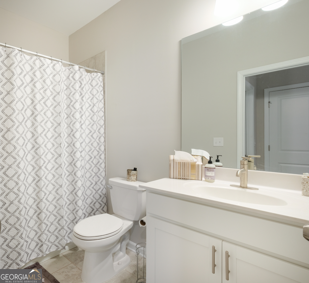 2247 Pink Hawthorn Drive Buford, GA 30518 - Photo 21 of 43 a bathroom with a sink a toilet and a mirror