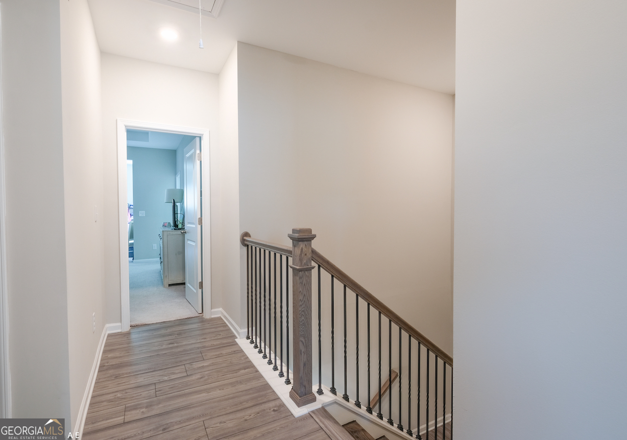 2247 Pink Hawthorn Drive Buford, GA 30518 - Photo 23 of 43 a view of a hallway with wooden floor