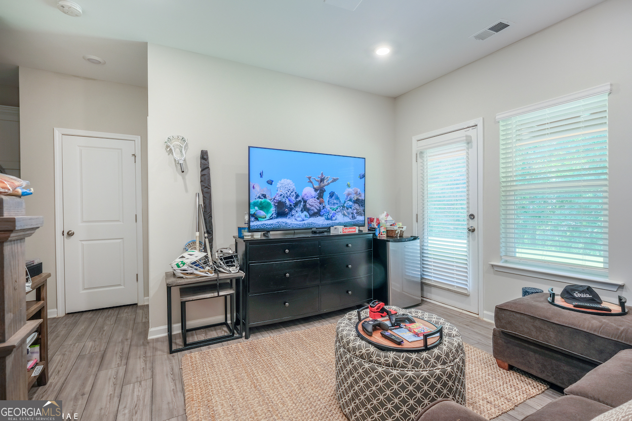 2247 Pink Hawthorn Drive Buford, GA 30518 - Photo 24 of 43 a living room with furniture and a flat screen tv