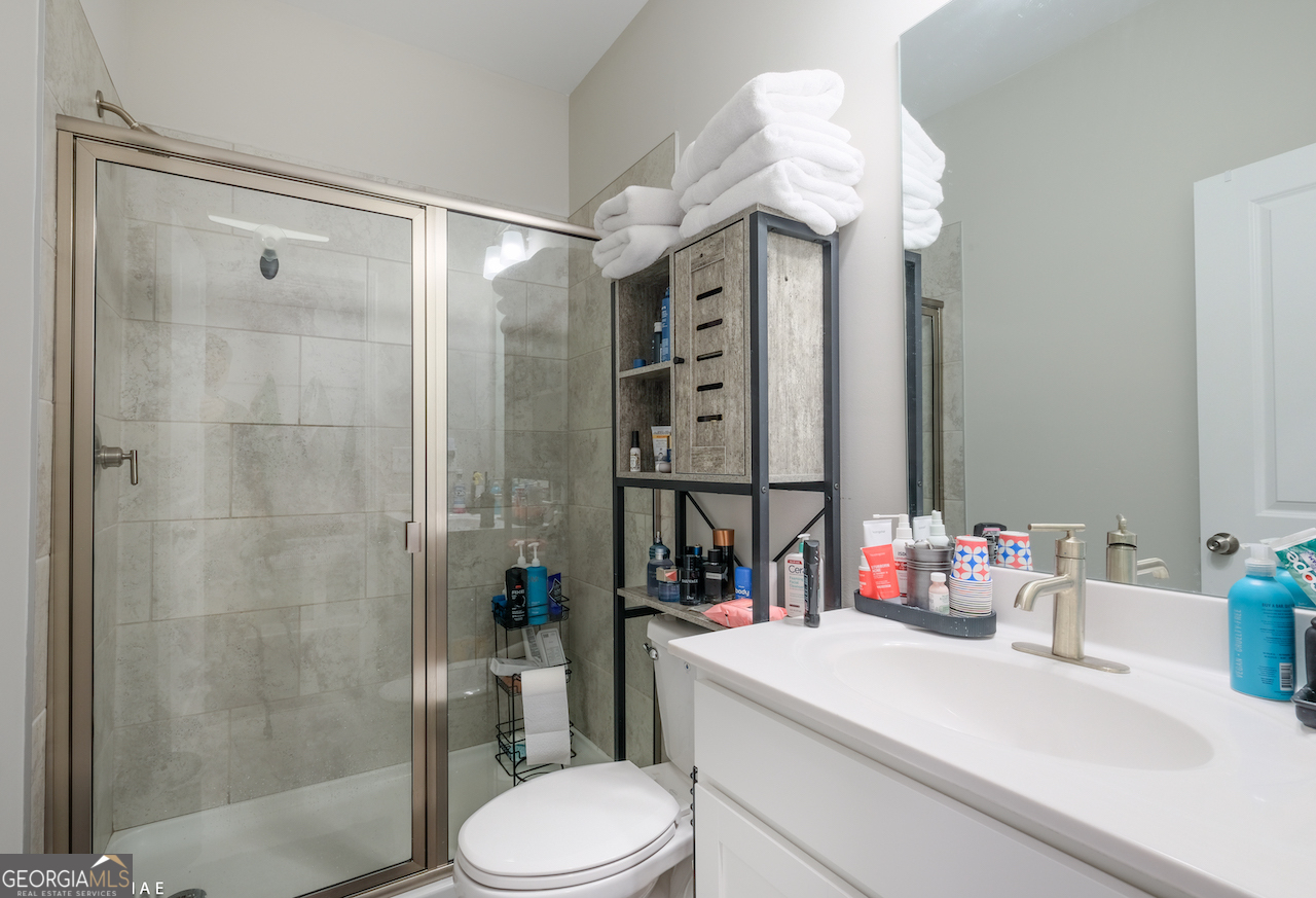 2247 Pink Hawthorn Drive Buford, GA 30518 - Photo 25 of 43 a bathroom with a sink vanity mirror and toilet