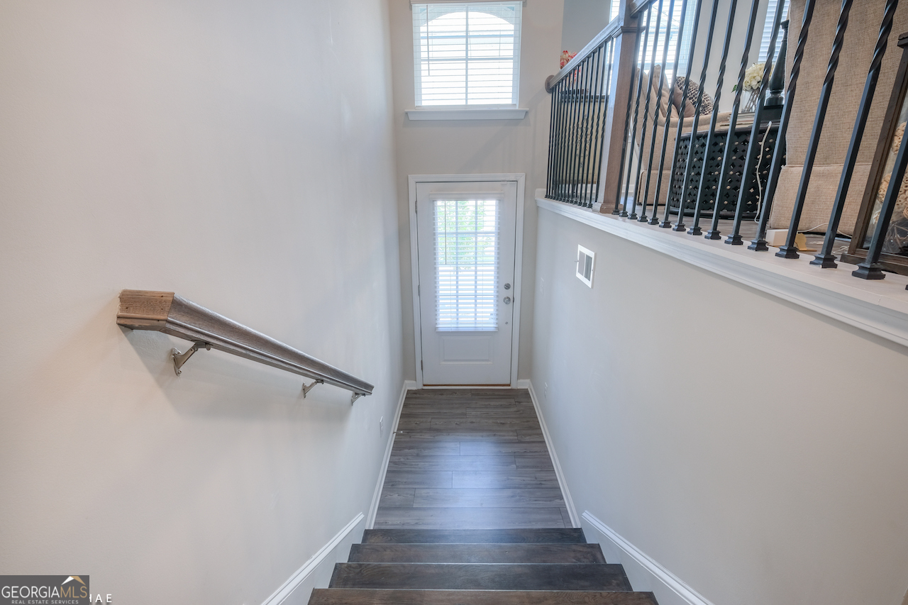 2247 Pink Hawthorn Drive Buford, GA 30518 - Photo 26 of 43 a view of a hallway with wooden floor and staircase