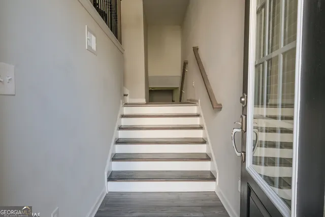 a view of staircase with white walls and a window
