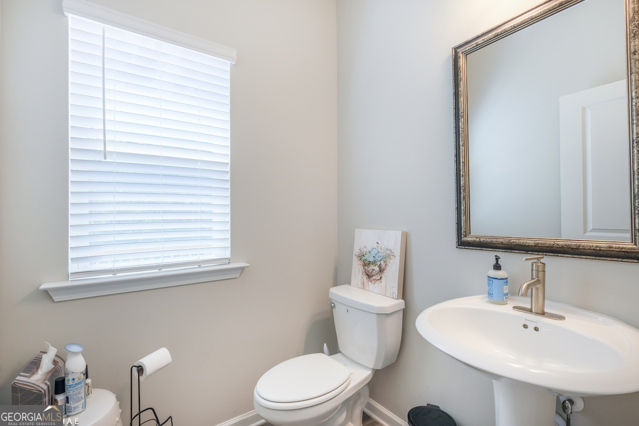 2247 Pink Hawthorn Drive Buford, GA 30518 - Photo 9 of 43 a bathroom with a sink a toilet and a mirror
