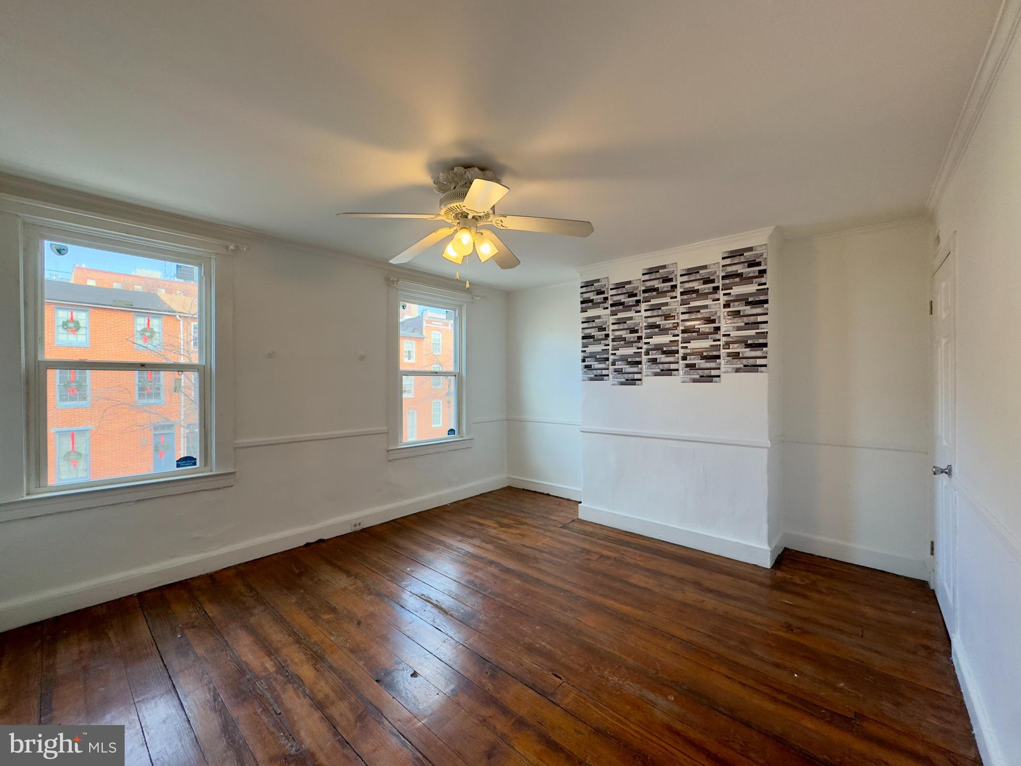 665 Portland Street Baltimore, MD 21230 - Photo 11 of 19 a view of an empty room with wooden floor and a window