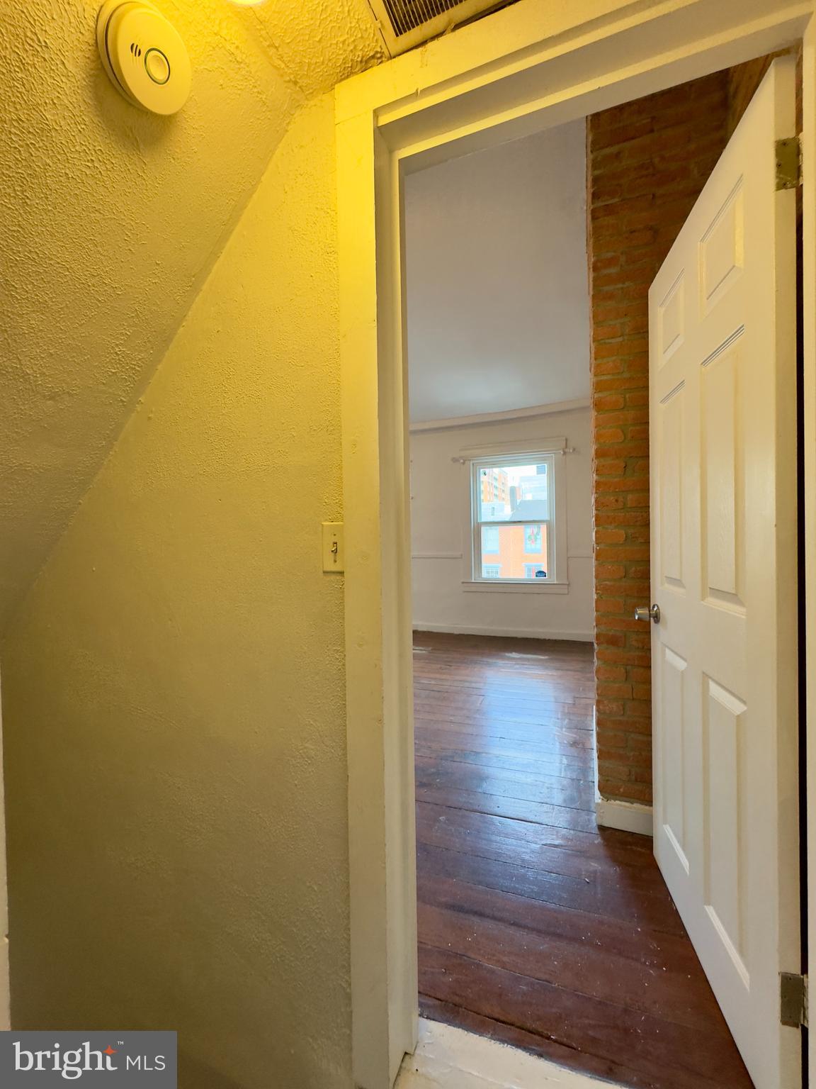 665 Portland Street Baltimore, MD 21230 - Photo 15 of 19 a view of a hallway with wooden floor