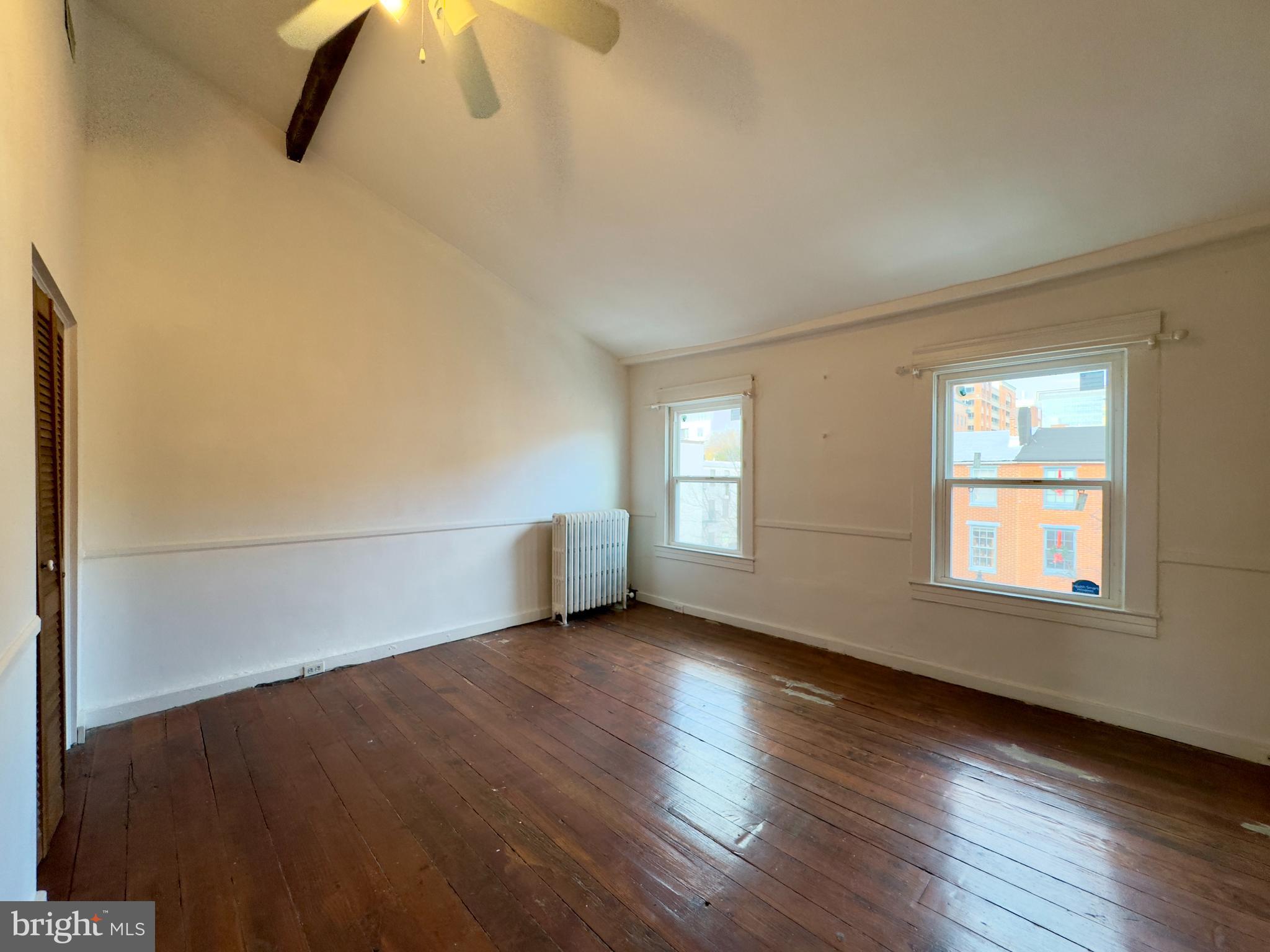 665 Portland Street Baltimore, MD 21230 - Photo 16 of 19 a view of a livingroom with wooden floor and window