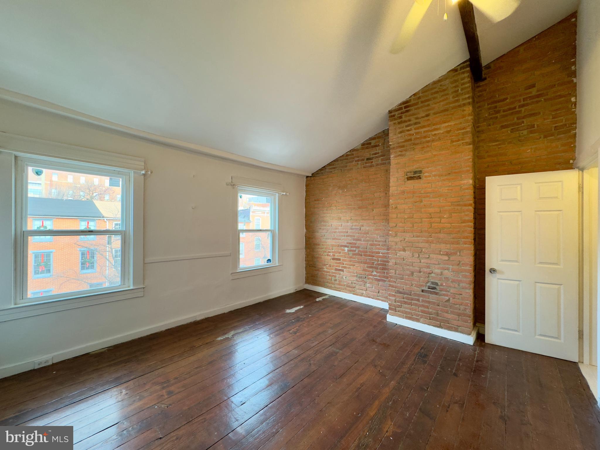 665 Portland Street Baltimore, MD 21230 - Photo 2 of 19 a view of a livingroom with wooden floor and a window
