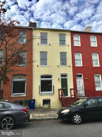 a car parked in front of a brick house