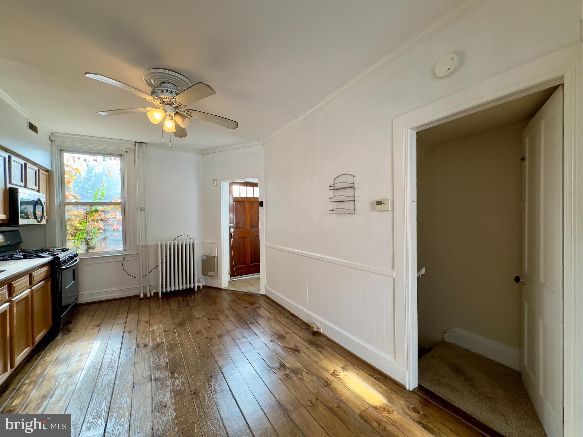 665 Portland Street Baltimore, MD 21230 - Photo 6 of 19 a view of a livingroom with hardwood floor and a ceiling fan