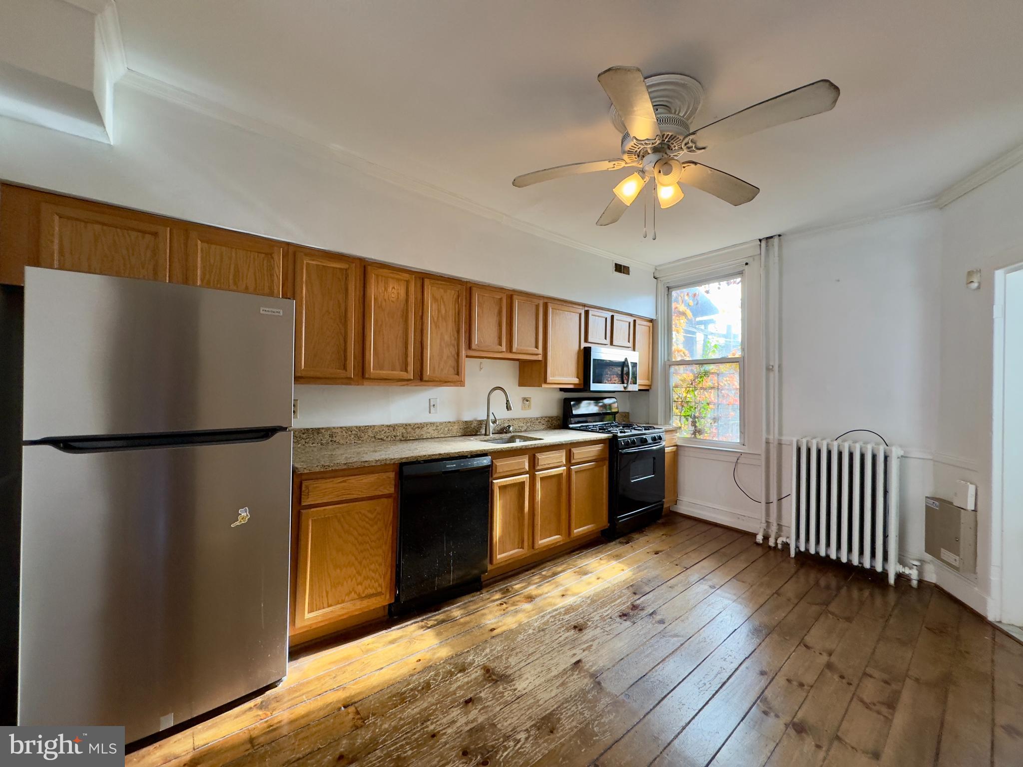 665 Portland Street Baltimore, MD 21230 - Photo 7 of 19 a kitchen with granite countertop a refrigerator and a sink