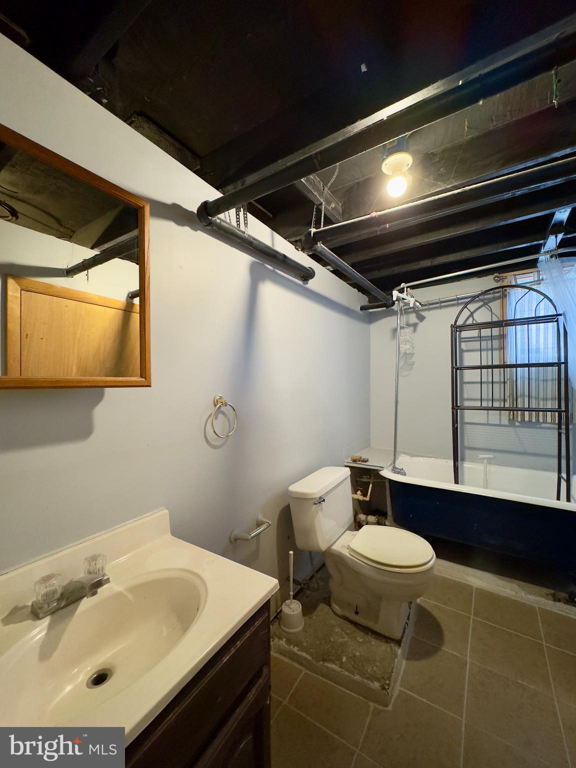 665 Portland Street Baltimore, MD 21230 - Photo 9 of 19 a bathroom with a sink and a mirror