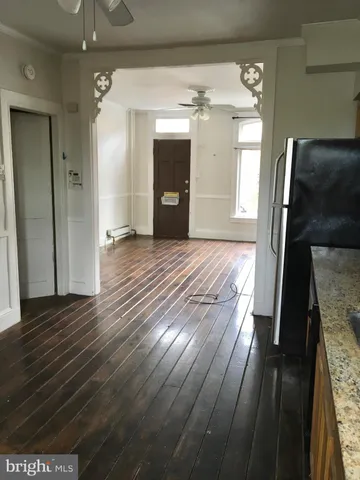 a kitchen with stainless steel appliances granite countertop a refrigerator a sink dishwasher a stove with wooden cabinets and floor